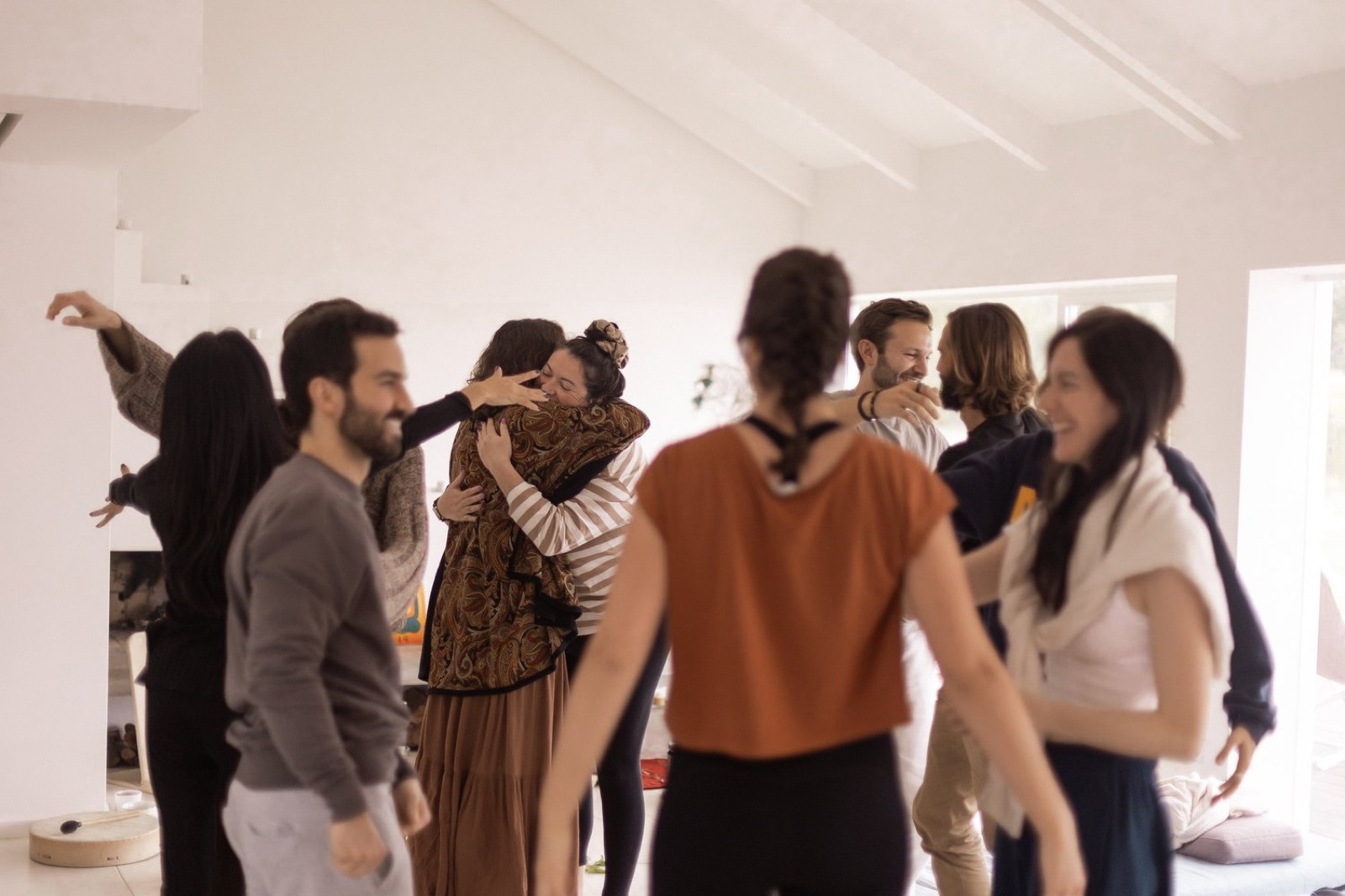 The retreat group embracing together in a bright room
