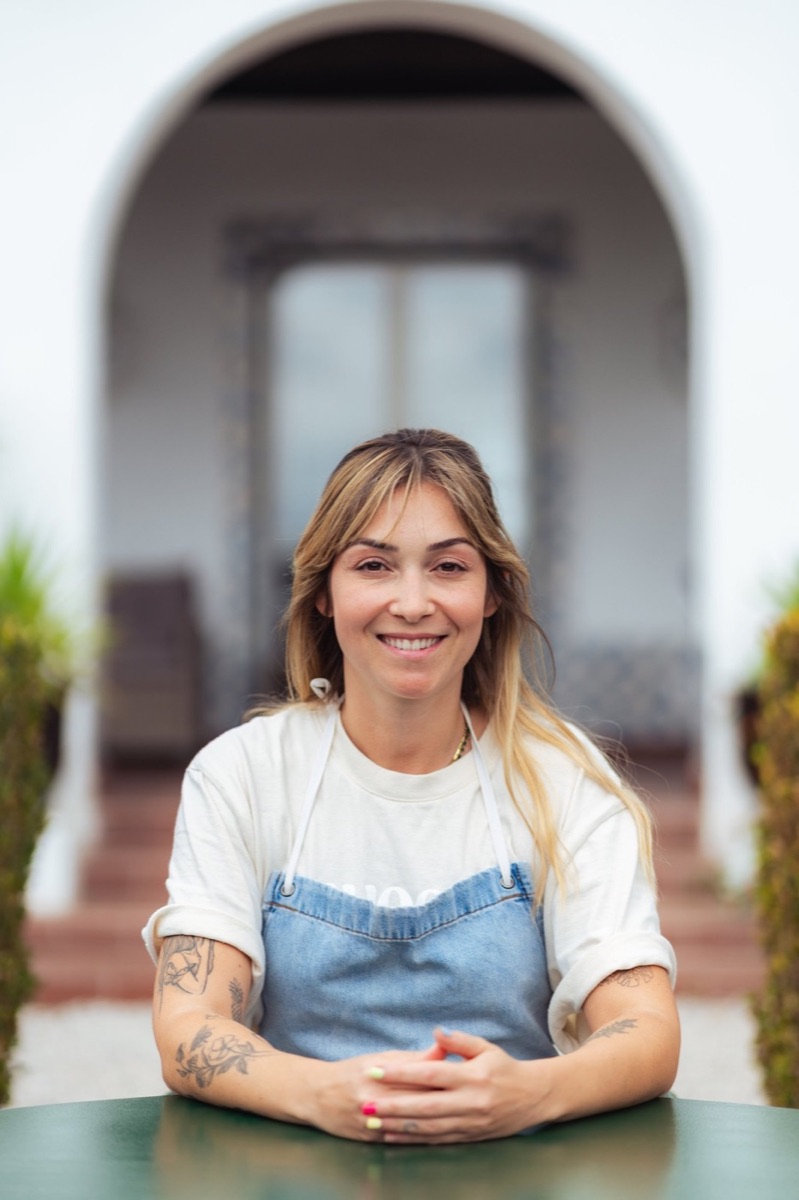 Amábile Kolenda, the retreat chef, smiling in front of the quinta