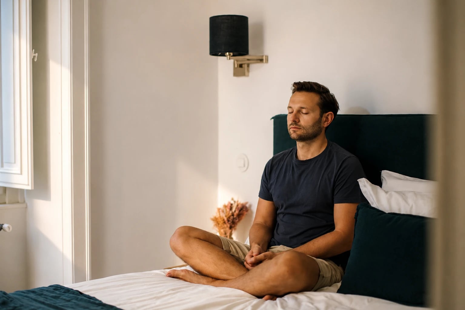 Sam Wysock-Wright meditating on the bed