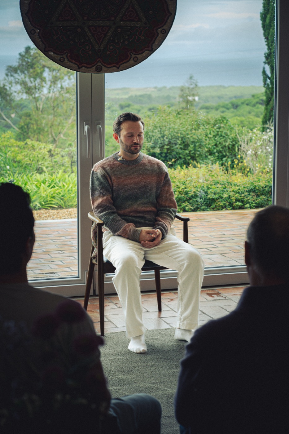 Sam meditating before a window looking out over the landscape near Lisbon.